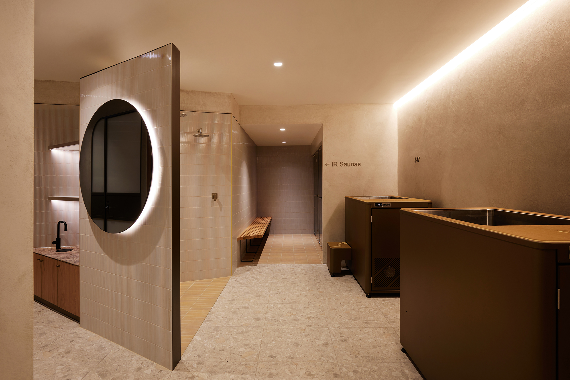 modern interior, earth tones, stone, terracotta, limewash, ice bath, shower niche, backlit circular mirror, marble, finger tiles