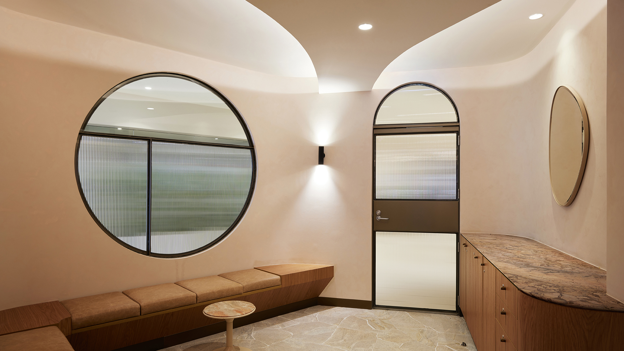 modern, bright interior, circular window, arch, curved ceiling, earthy, bronze, timber, leather, marble counter, crazy paving